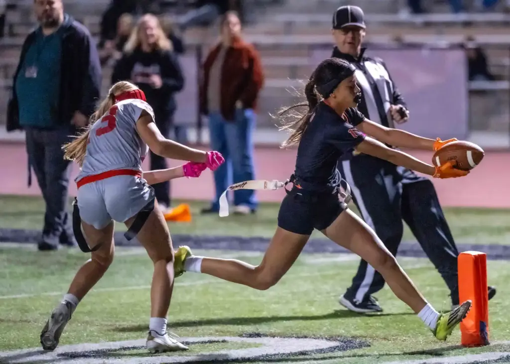 Huntington Beach running back Kyla Uno (1) carries the ball...
