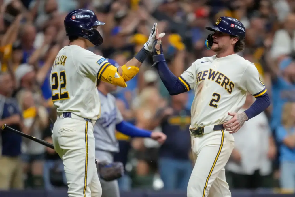 The Milwaukee Brewers’ Brice Turang, right, celebrates with teammate Christian...