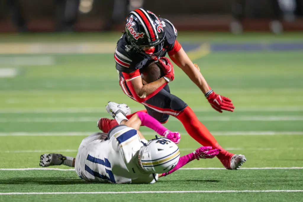 Hart High School’s Matix Frithsmith (4) is tackled by West...