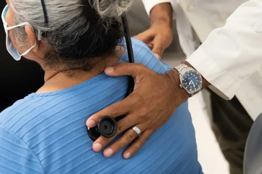 Naman Shah examines a patient at Monrovia Health Center, a...