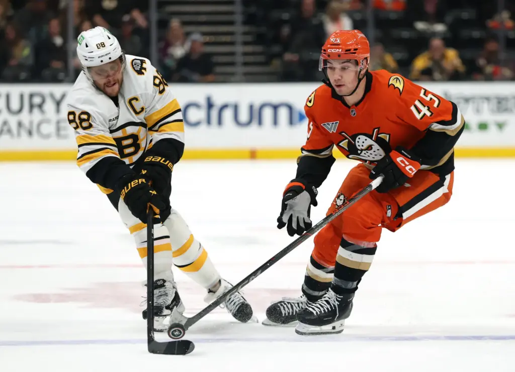 The Ducks’ Beckett Sennecke, right, loses the puck to the...