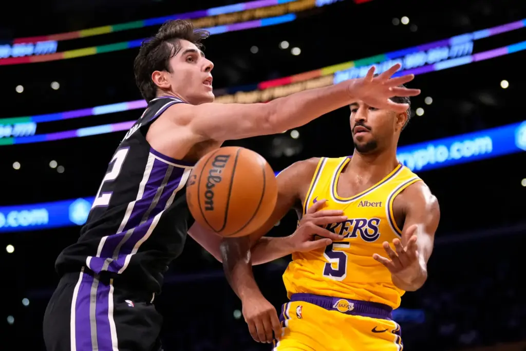 Lakers guard Quentin Grimes, right, passes the ball as Sacramento...