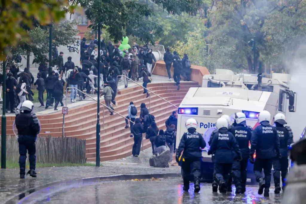 Protesters clash with riot police during a national demonstration against government budget cuts.