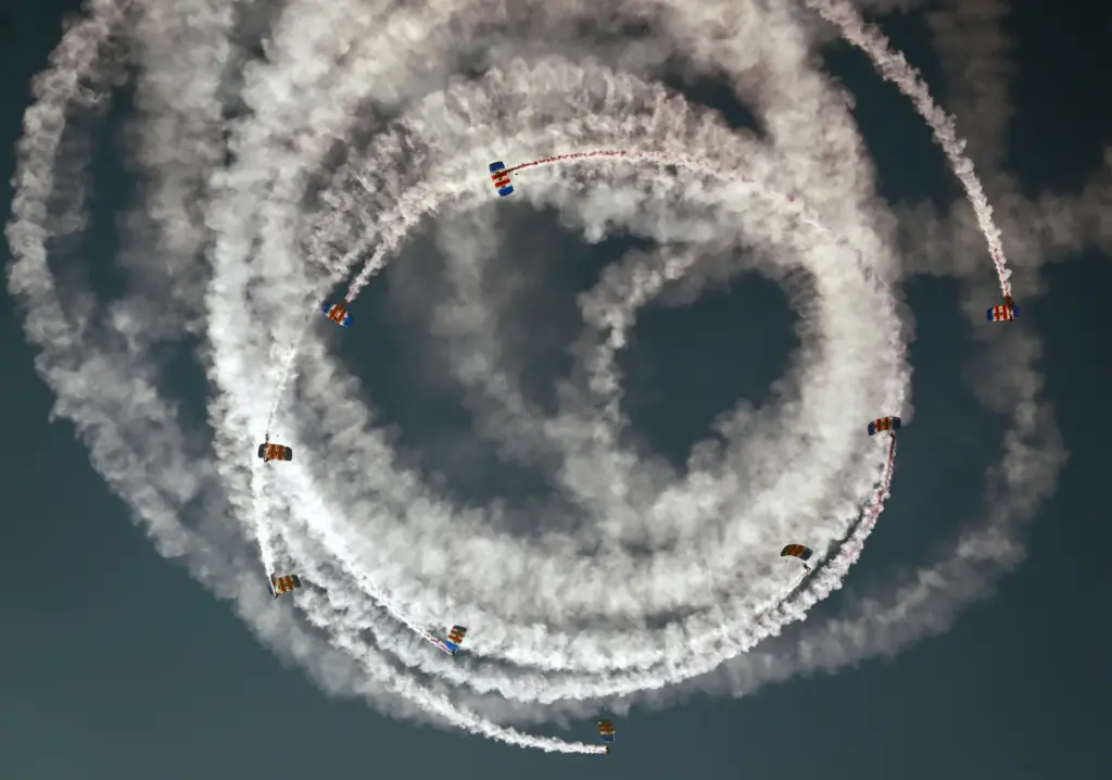 The Royal Air Force Falcons parachute team jump over the...