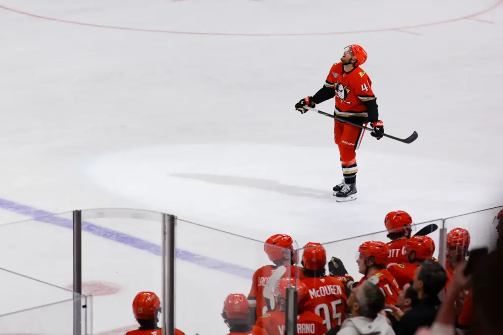 Ducks center Tim Washe skates to the bench after scoring...