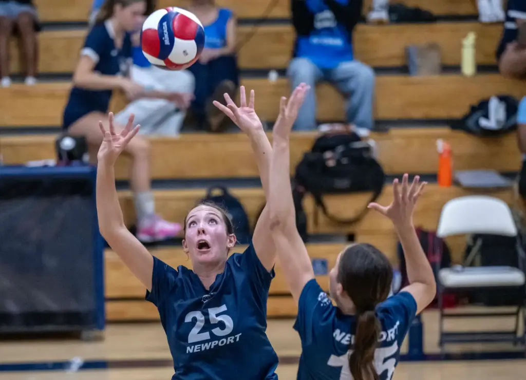 Newport Harbor setter Avery Hansen (25) sets the ball to...