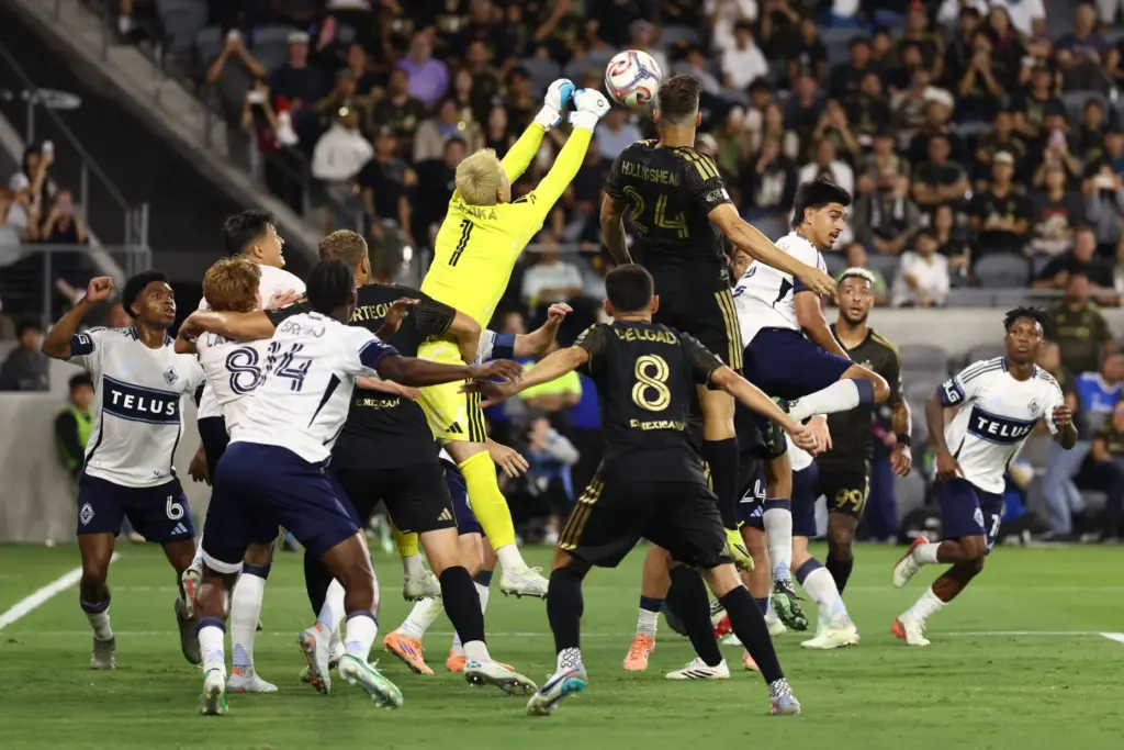 Vancouver Whitecaps goalkeeper Yohei Takaoka (1) deflects the ball against...