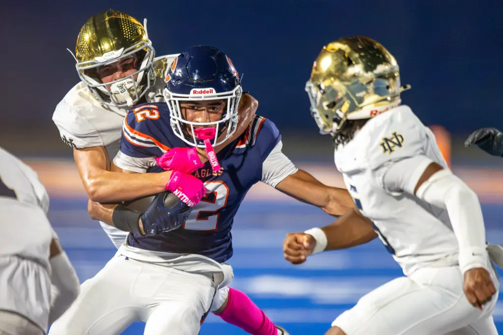 Chaminade High Schoolâs Andrew Cordero (12) is wrapped up by...