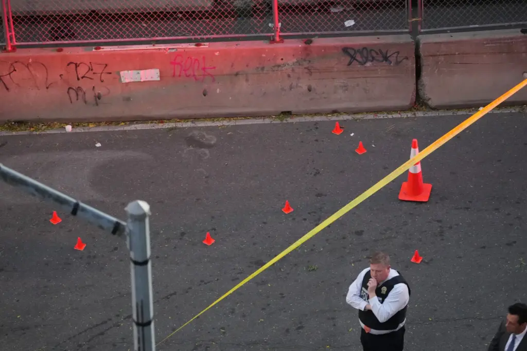 Law enforcement officers investigate after ICE agents shot and wounded...
