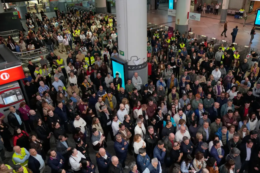 People observe a minute of silence in memory of the...
