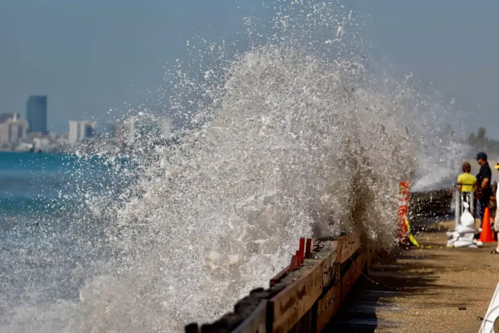 Waves continue to crash into the already heavily damaged boardwalk...