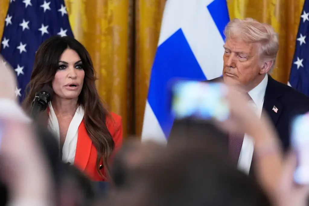 Kimberly Guilfoyle speaks as President Donald Trump listens.