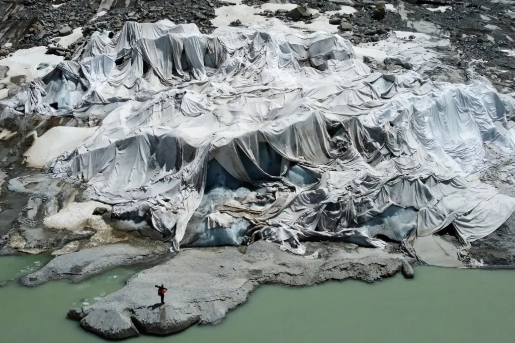 FILE — The Rhone Glacier near Goms, Switzerland, is partially...