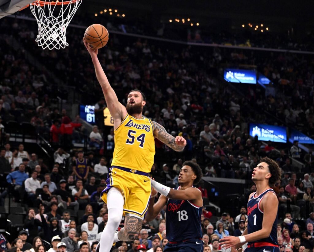 Lakers forward Sandro Mamukelashvili soars to the basket in front...