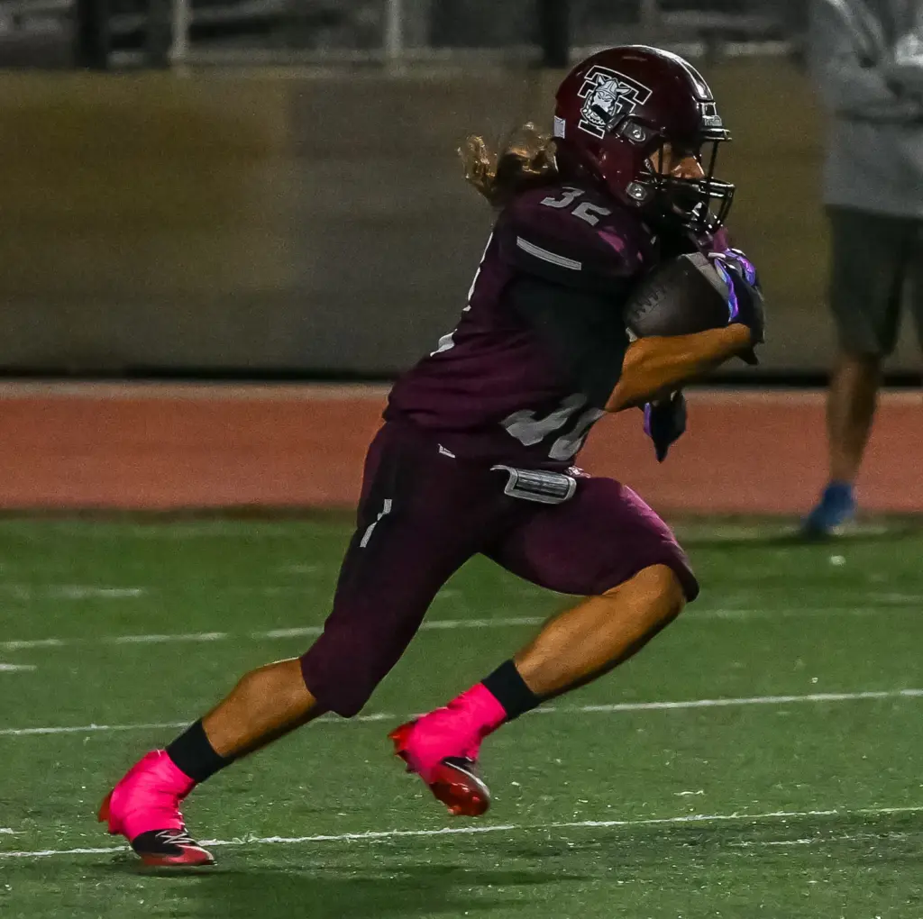 Torrance High running back Sonny Gomez rushes with the ball...