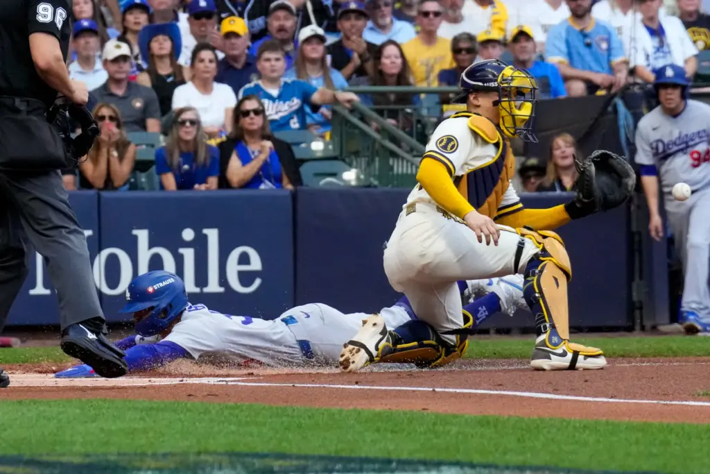 The Dodgers’ Mookie Betts scores on a sacrifice fly hit...
