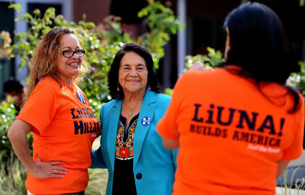 Dolores Huerta, center, poses for a picture with Gisel Couso...