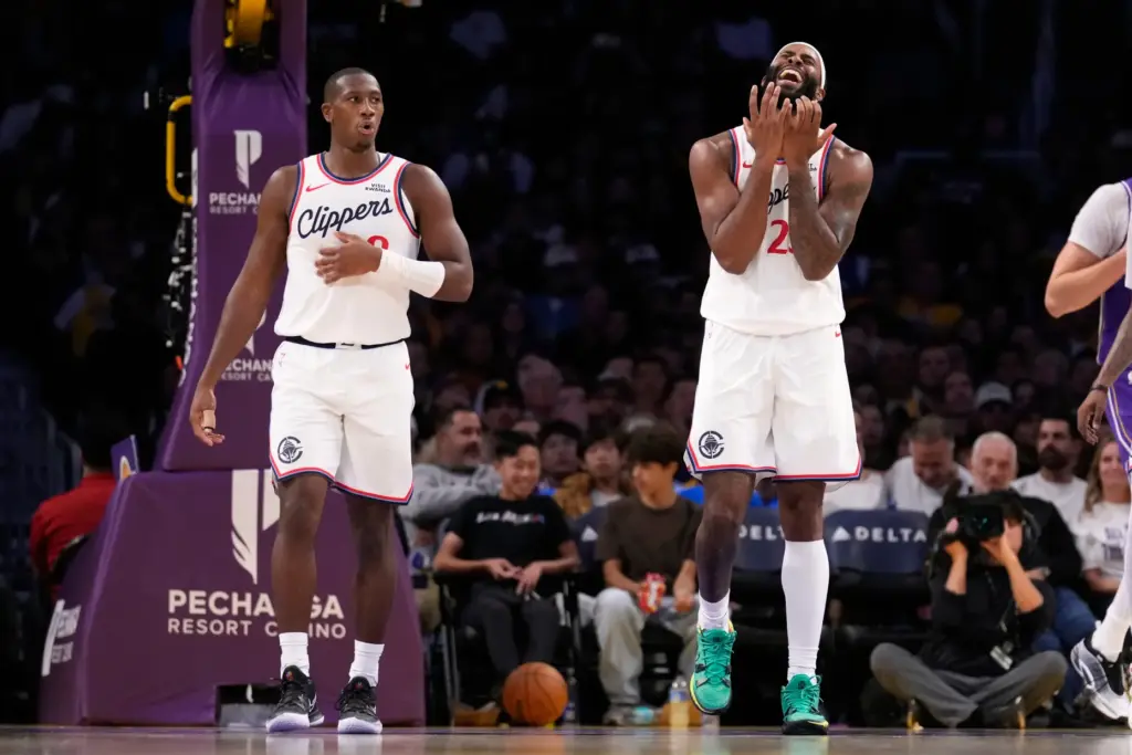 Clippers guard Kris Dunn, left, and forward/center Isaiah Jackson react...