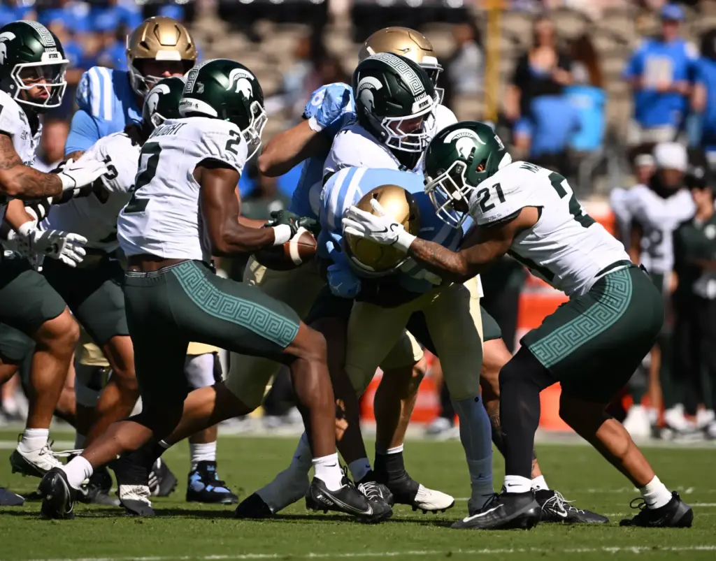Michigan State safety Devin Vaught (2) strips the ball from...