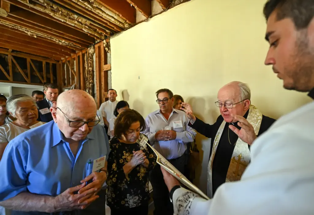 People pray as Bishop Kevin Vann blesses a future House...