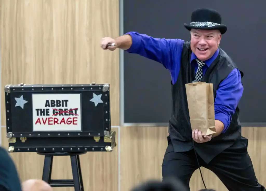 Abbit the Average performs magic tricks for kids in a...