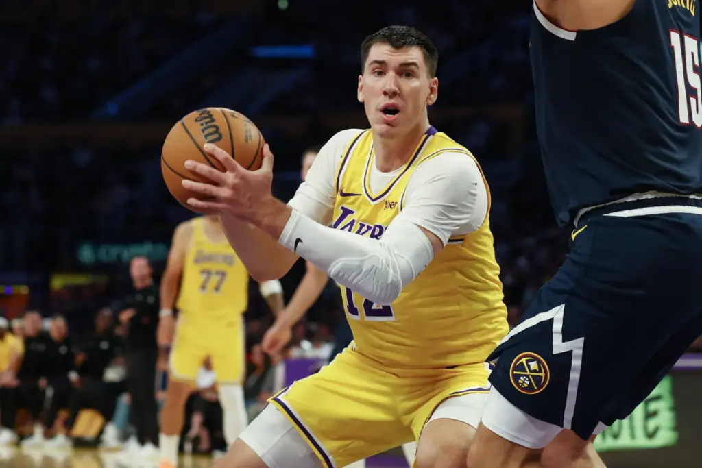 Lakers forward Jake LaRavia looks to pass the ball during...