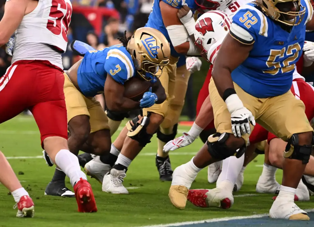 Running back Wayne Knight #3 of the UCLA Bruins runs...