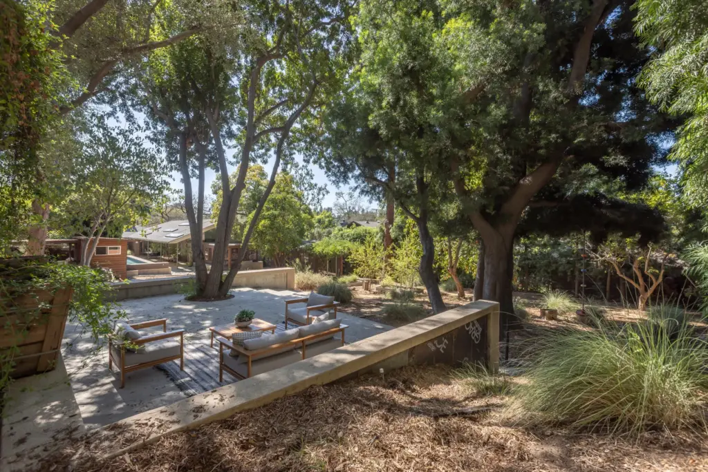 The backyard patio shaded by trees. (Photo by Hillary Campbell)