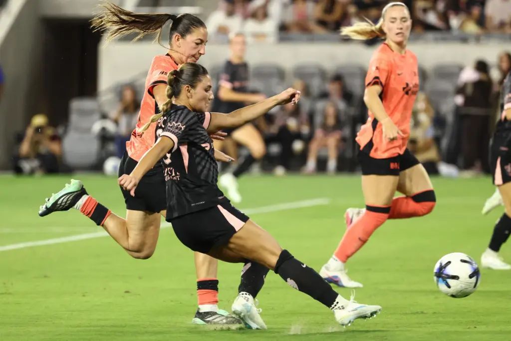 Angel City FC defender Gisele Thompson, front, kicks the ball...
