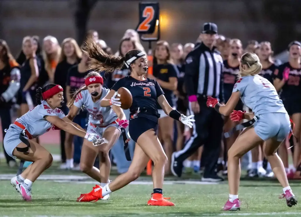 Huntington Beach wide receiver Brianna Massion (2) carries the ball...