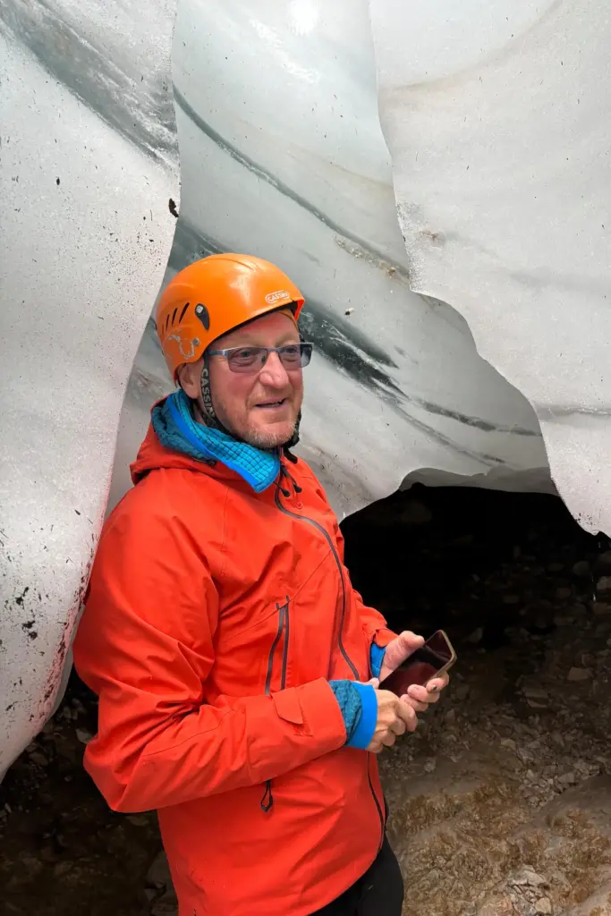 Andrej Slak, a mountain guide, stands next to remaining ice at the Skuta glacier.