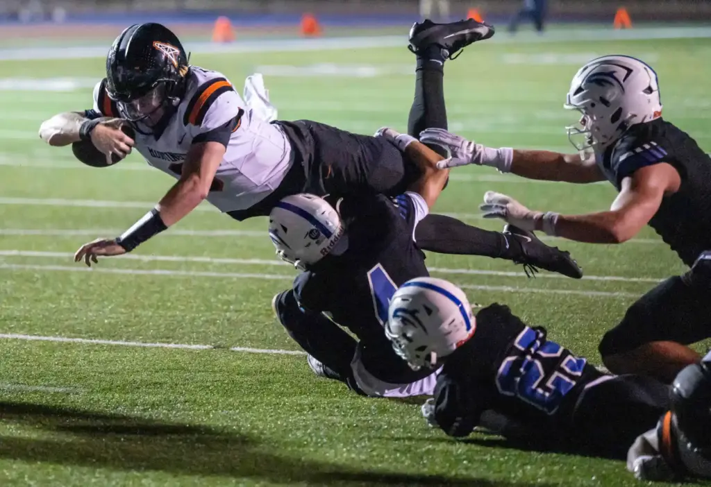 Huntington Beach quarterback Brady Edmunds (9) dives for a first...