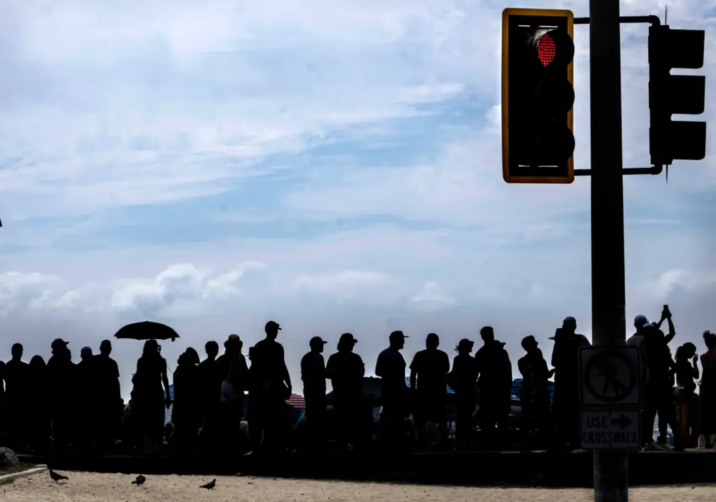 People line the beach to watch the AVP Laguna Beach...