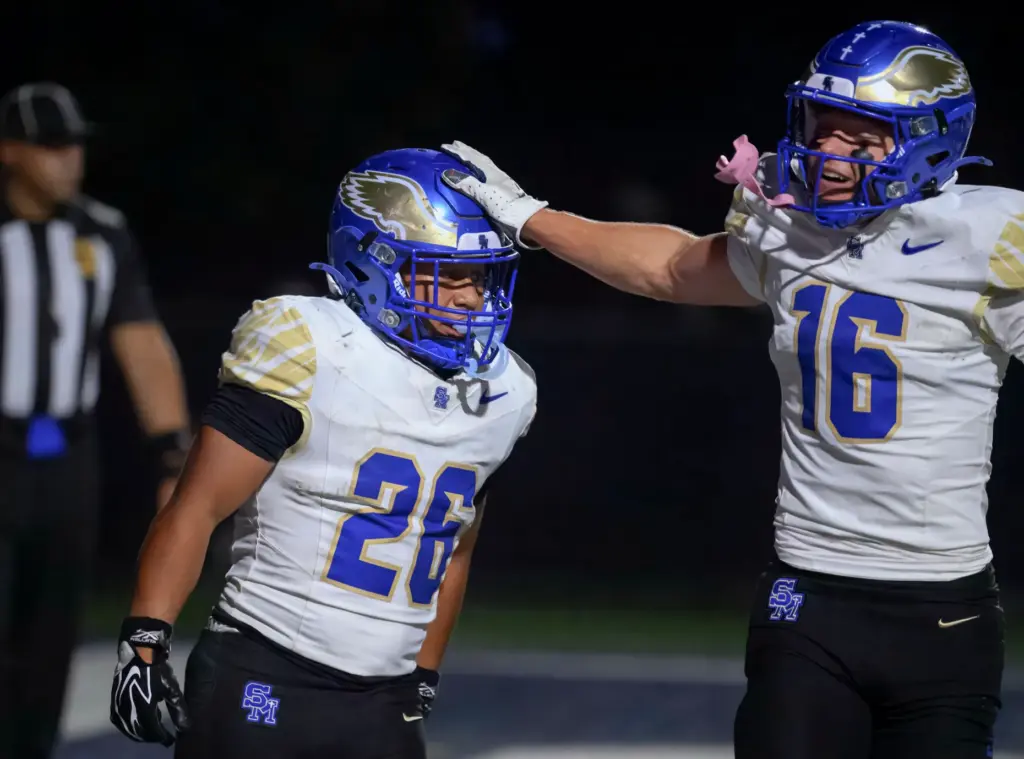 Santa Margarita running back Adrian Petero, left, is congratulated by...