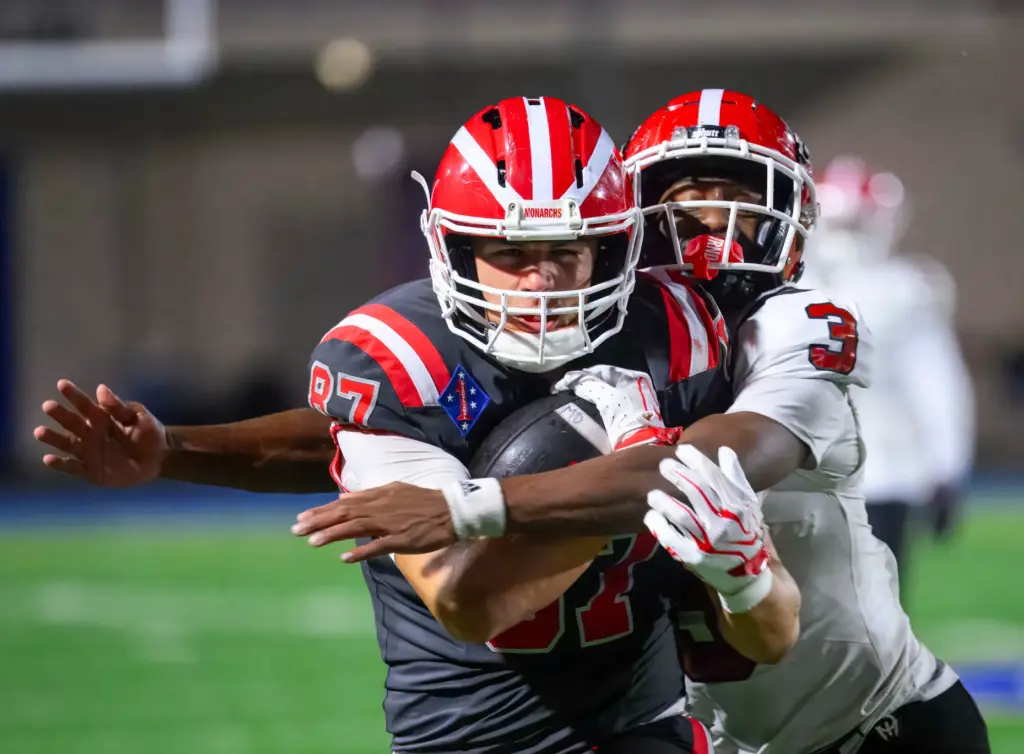 Mater Dei tight end Jacob Campizta hangs onto the ball...