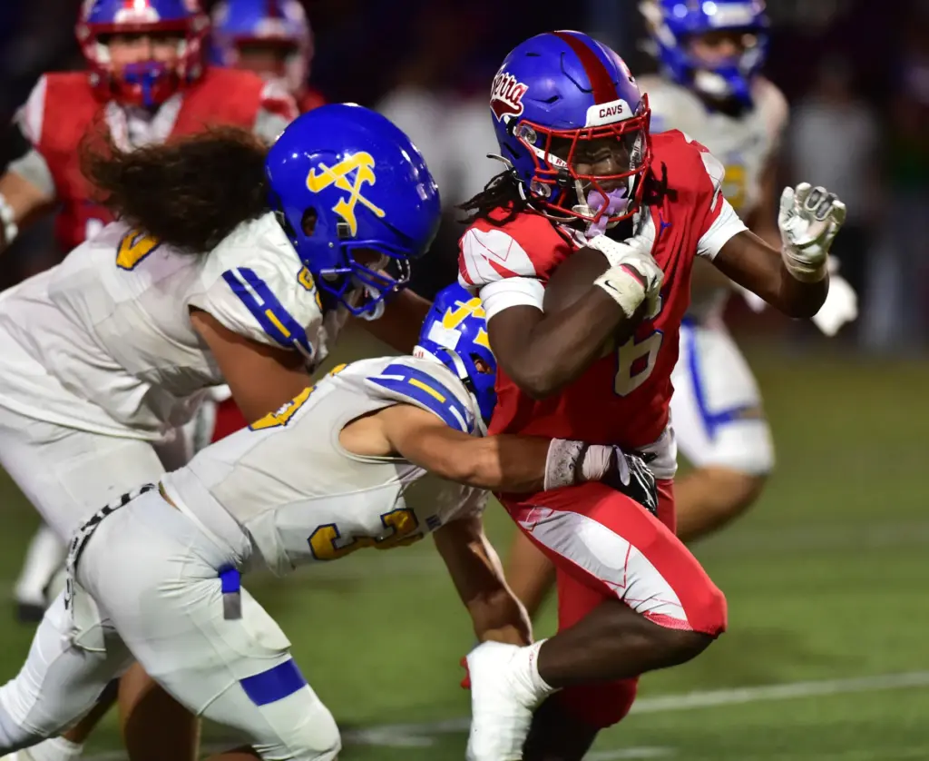 Serra running back James Robinson gets tackled by Bishop Amat...