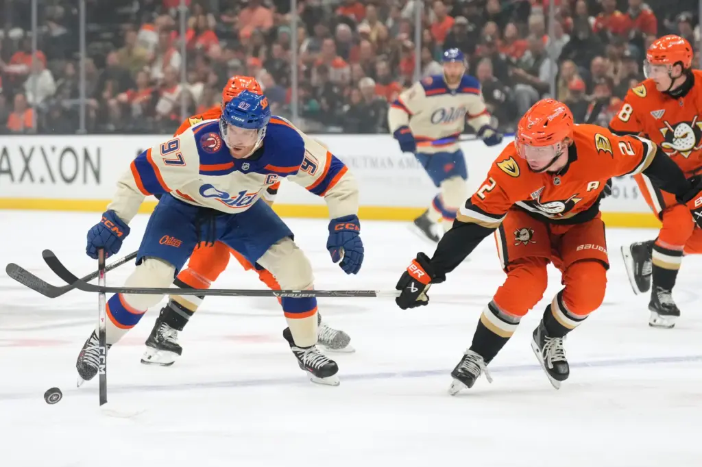 Edmonton Oilers center Connor McDavid, left, and Ducks defenseman Jackson...