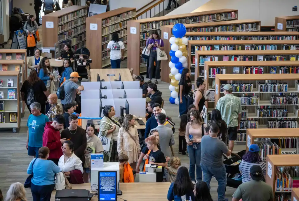 Residents browse bookshelves in the main hall of the Santa...