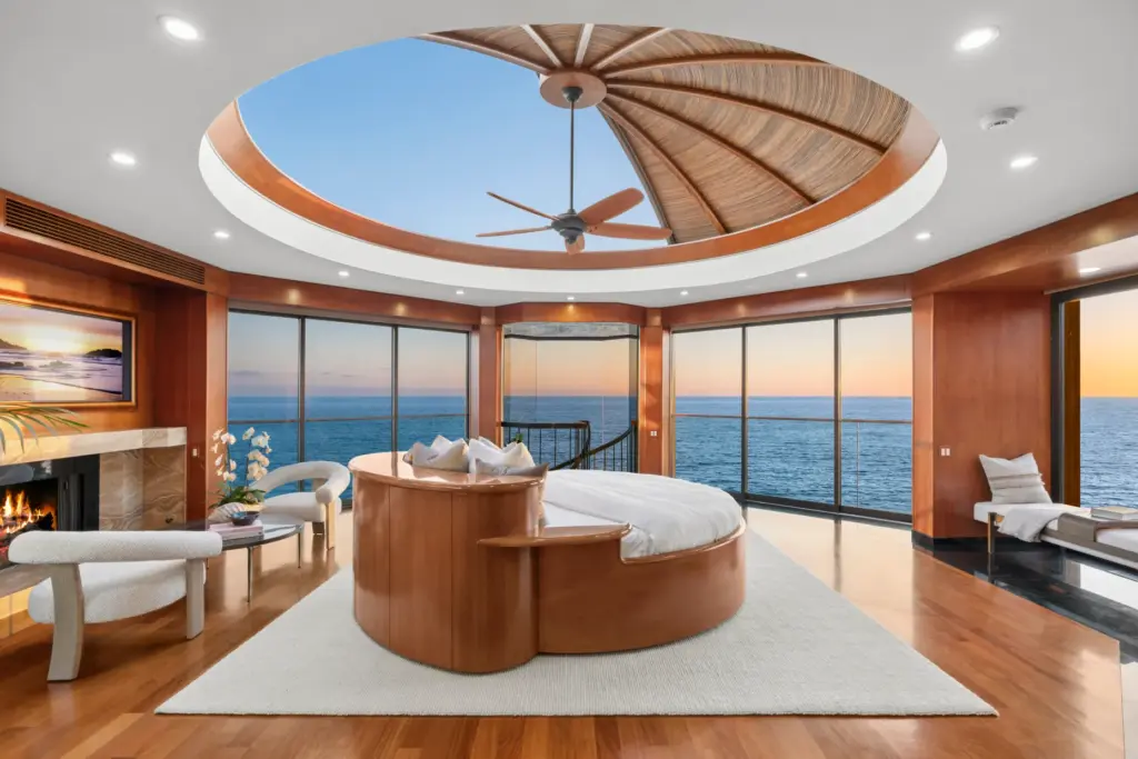 An automated circular ceiling retracts to expose the primary suite’s...
