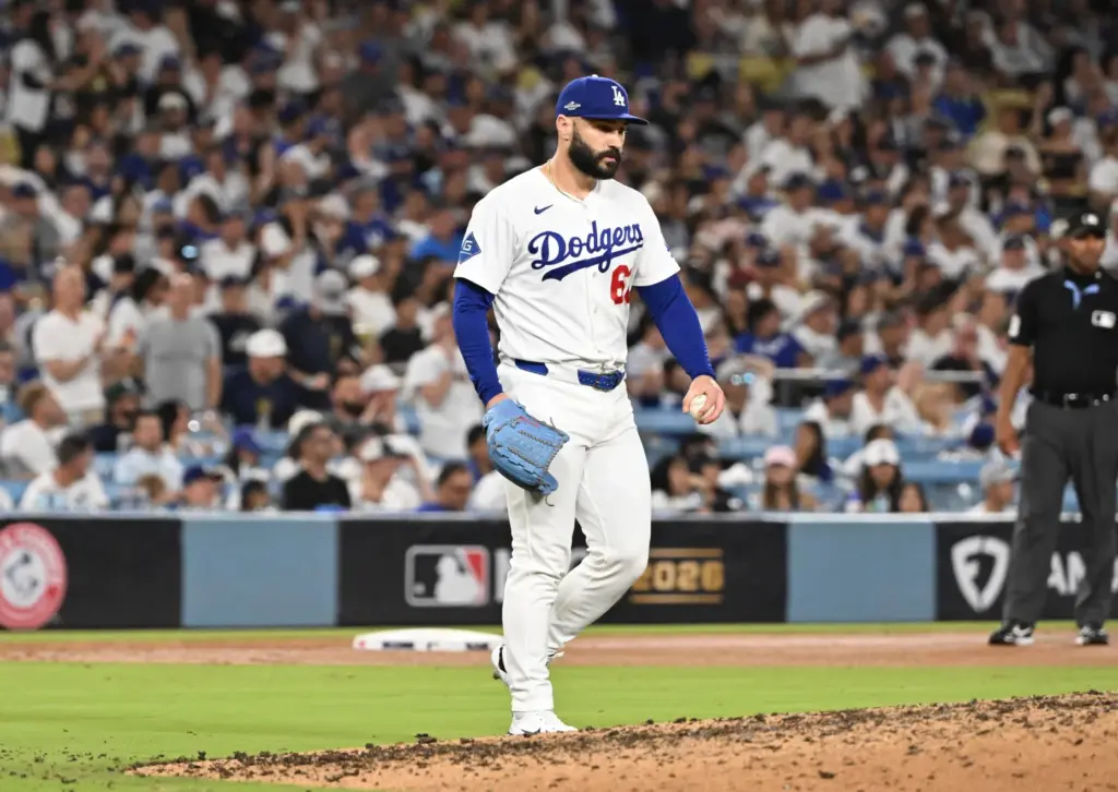 Dodgers relief pitcher Tanner Scott shows his frustration after giving...
