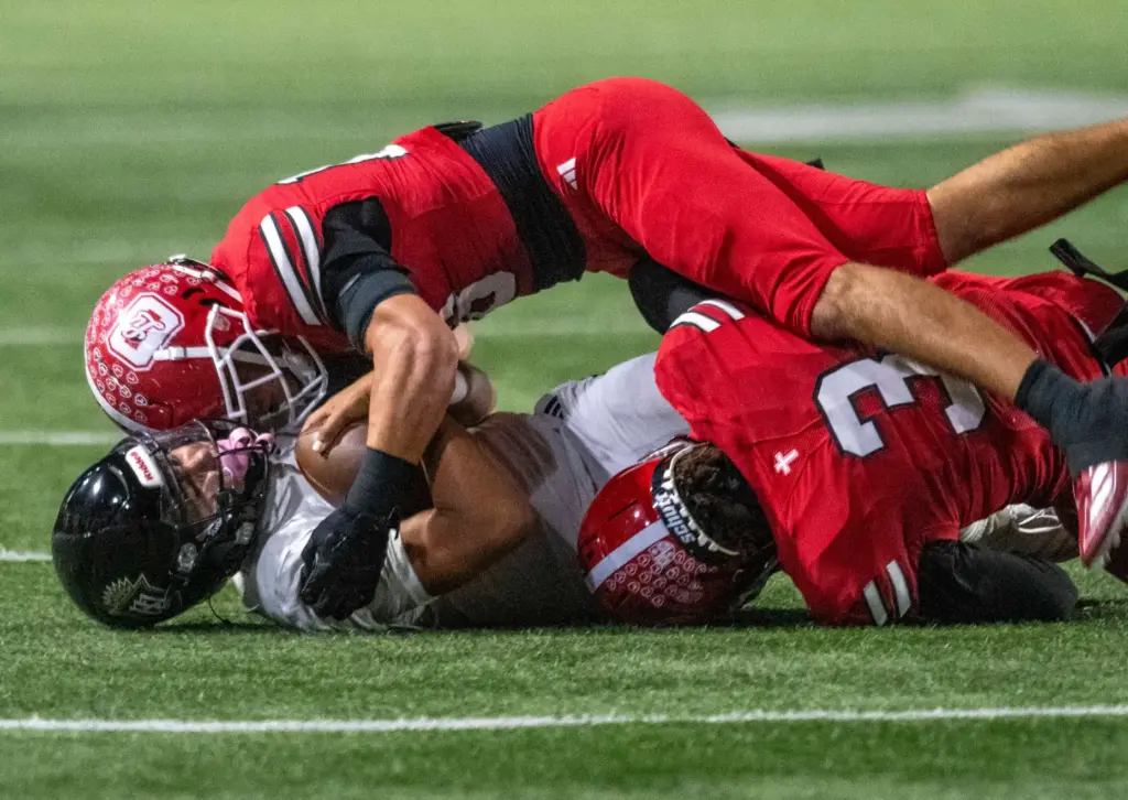 Serviteâs Gino Wang (3) gets sandwiched by two Orange Lutheran...