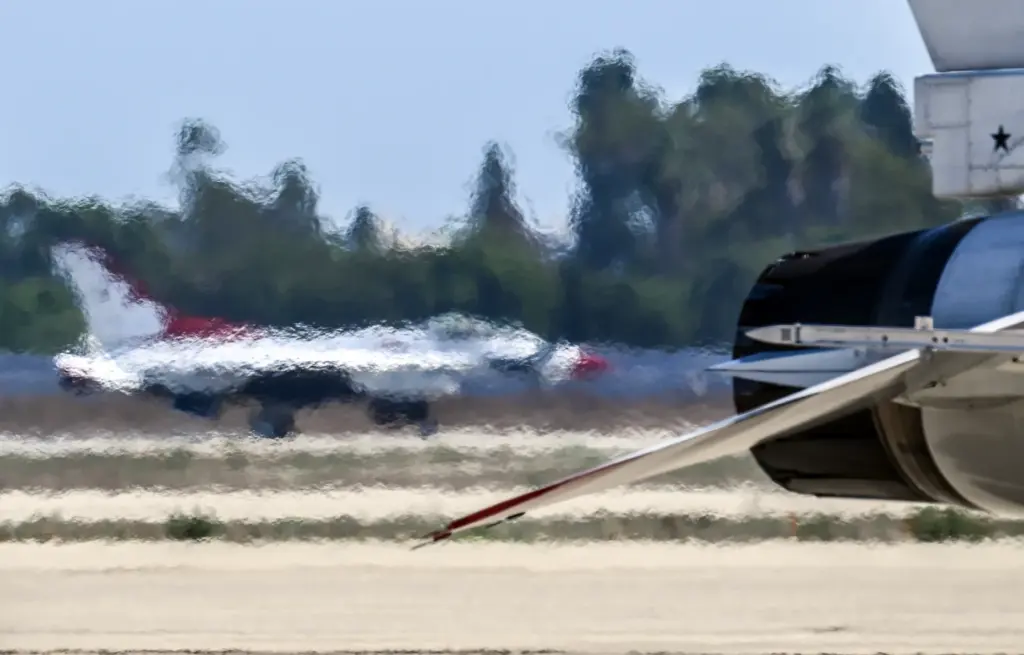 A United States Air Force Thunderbird passes then exhaust of...