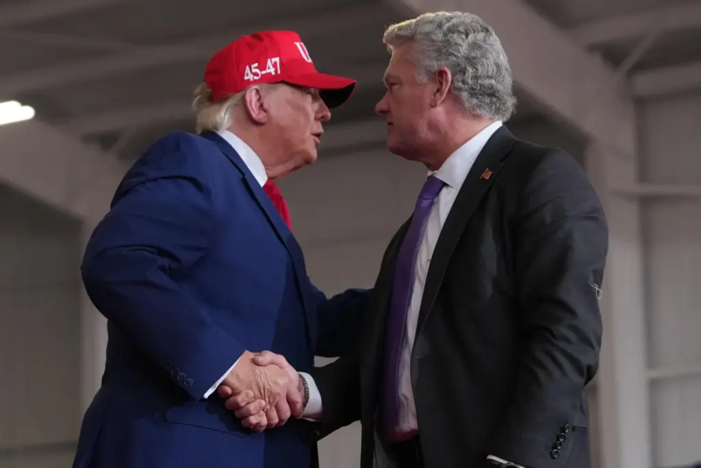 President Donald Trump shakes hands with Georgia U.S. Senate candidate...