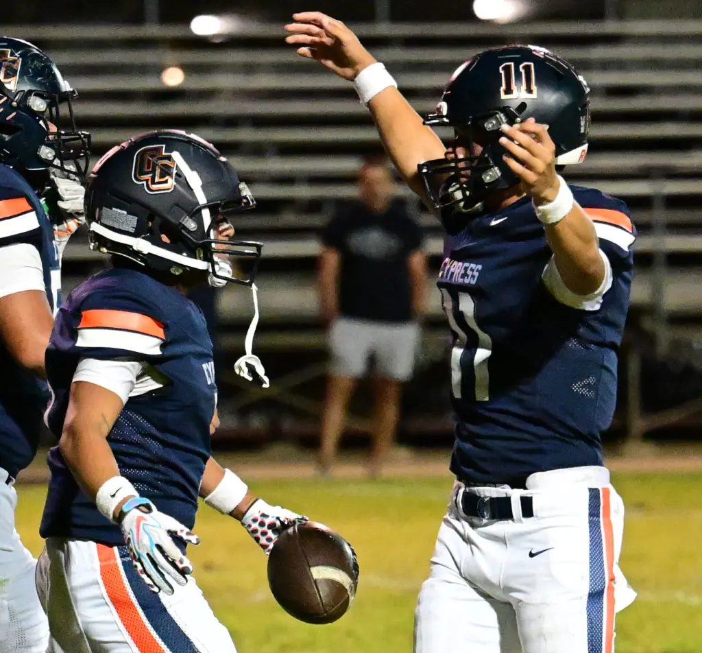 Jayson Bagsic #3 of Cypress is congratulated by Justin Hall...