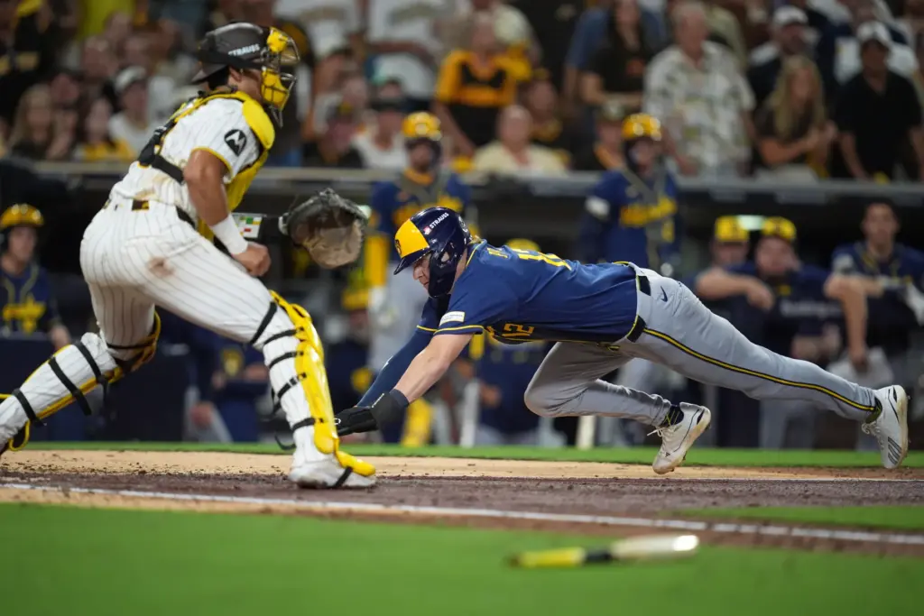 The Milwaukee Brewers’ Cooper Pratt, right, scores past San Diego...
