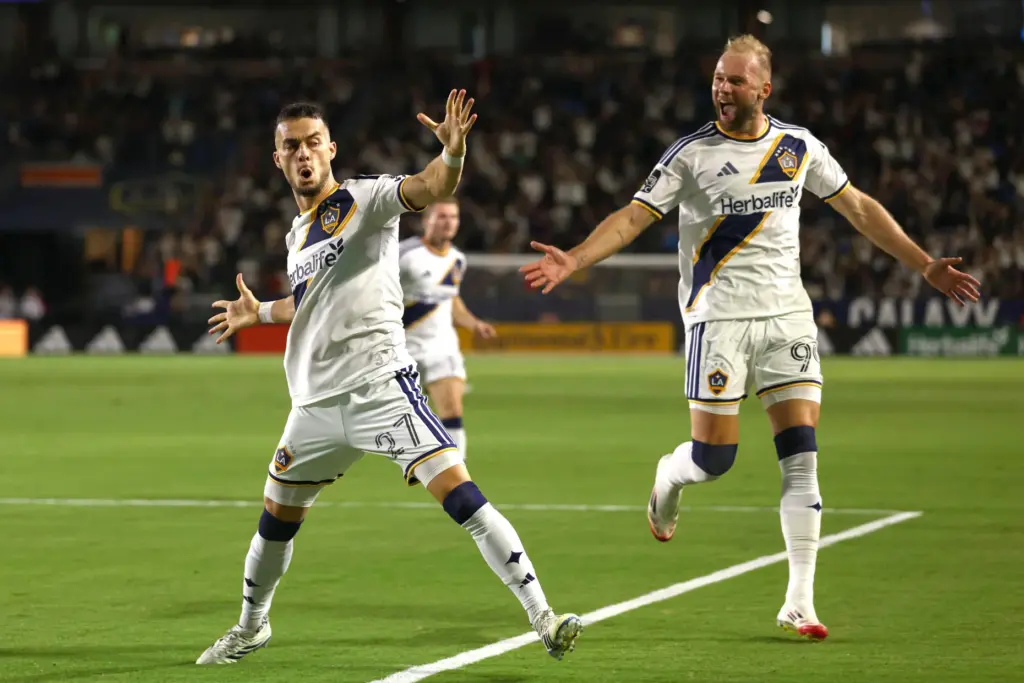 Los Angeles Galaxy midfielder Erik Thommy, left, celebrates with teammate...