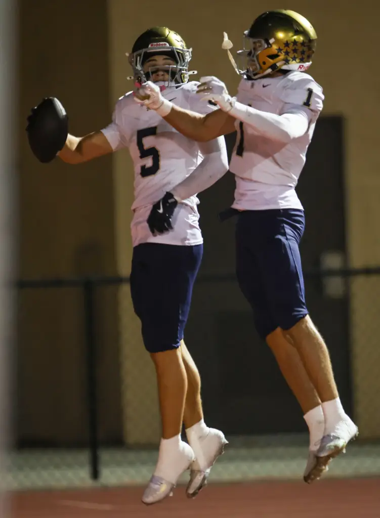 San Juan Hillsâ Luke Frith, left, celebrates a touchdown with...