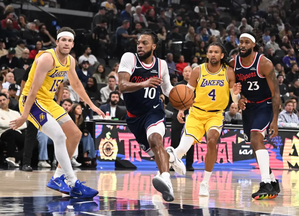 Clippers point guard Darius Garland drives to the basket past...