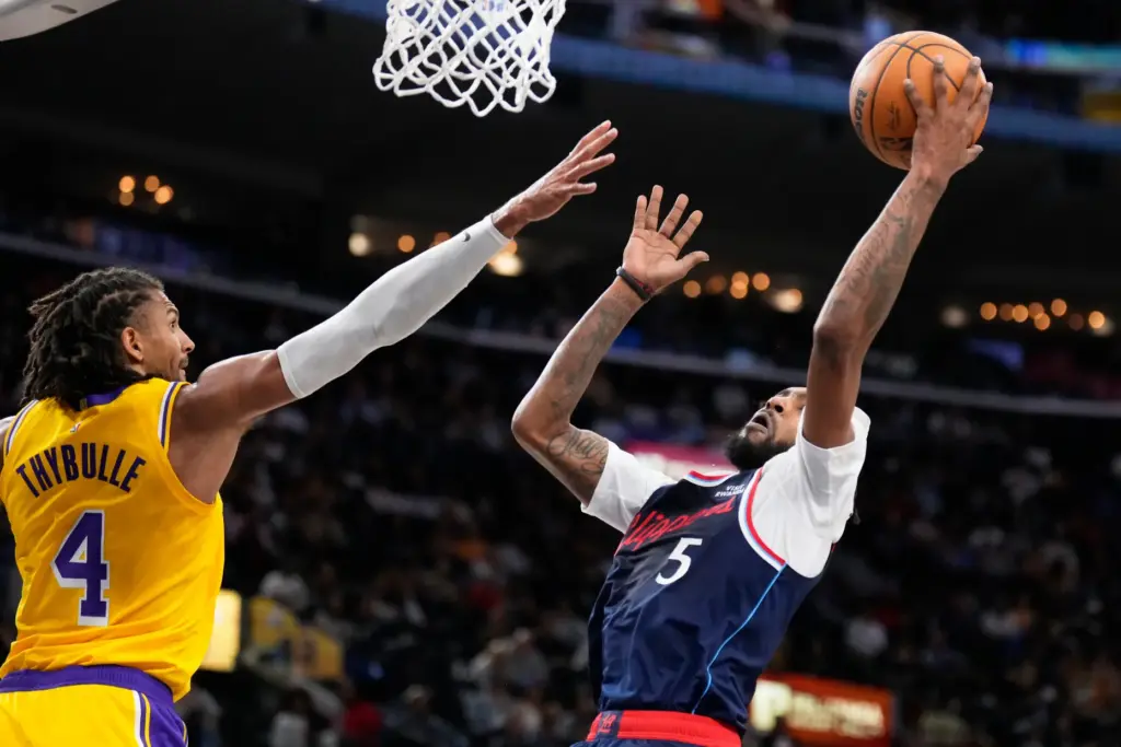 Clippers forward Derrick Jones Jr., right, shoots as Lakers guard...