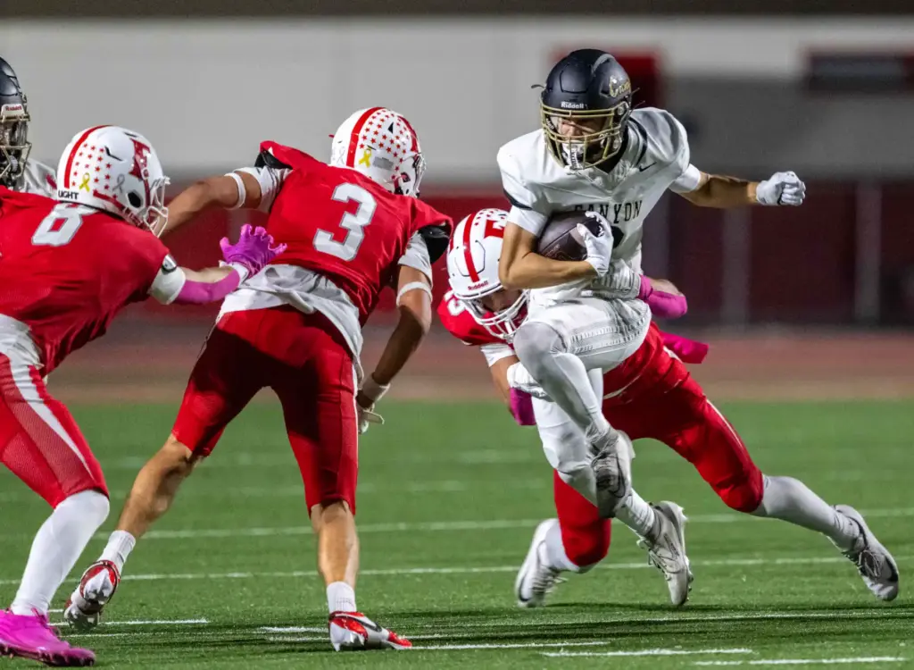 Canyon wide receiver Kasin Leidholdt (3) breaks a tackle while...